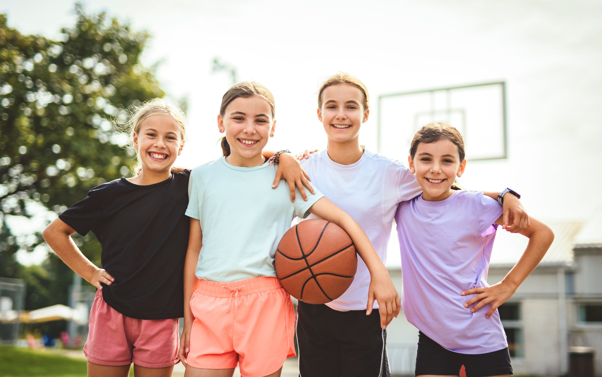 Childs girls Team in sportswear playing basketball game